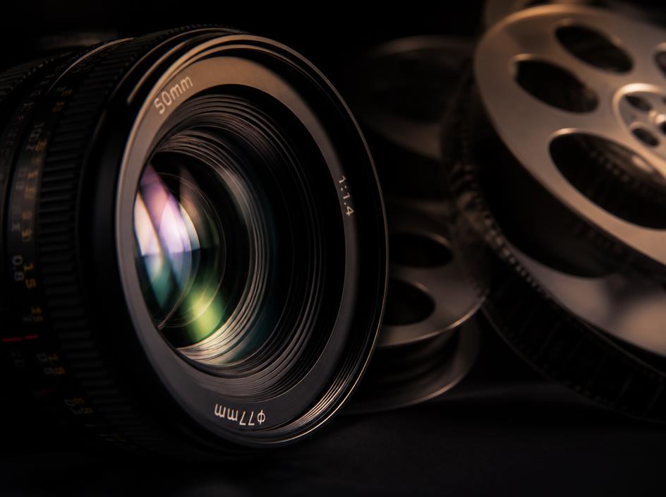 High-end camera lens and film reels in a sophisticated studio